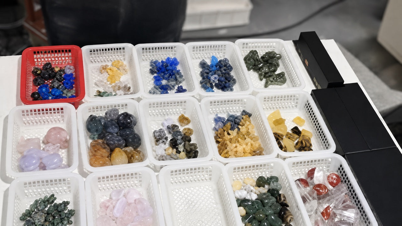 Assorted wholesale crystal products separated in baskets for inventory refresh selection.