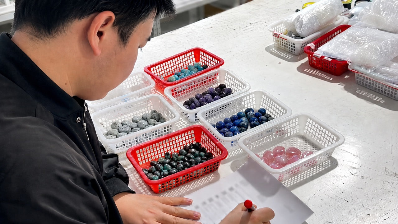 Wholesale crystal products in separate baskets during an order review.