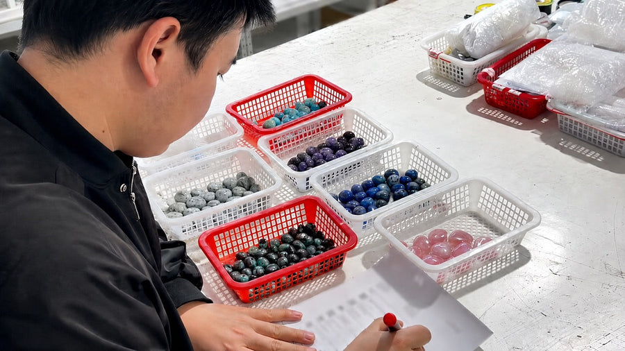 Wholesale crystal products in separate baskets during an order review.