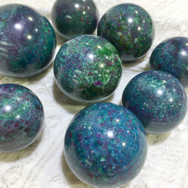 Crystal sphere for ornament ruby in kyanite sphere