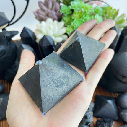 Shungite pyramid carving with geometric triangular sides