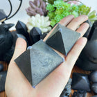 Shungite pyramid carving with geometric triangular sides